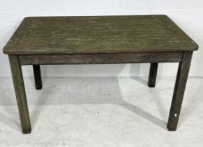 A weathered wooden garden table