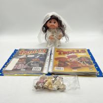 A vintage Troll "bride" doll along with issues 1 to 19 of The Trolls magazine in a folder. Lot