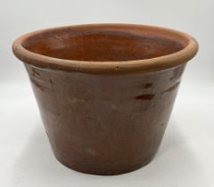 A small glazed terracotta dairy bowl