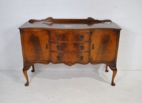 A serpentine-fronted sideboard, with three drawers and cupboards either side, raised on cabriole