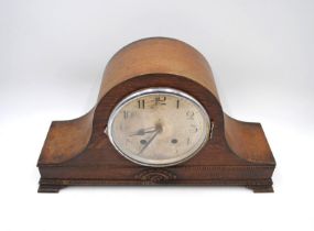 An oak cased mantel clock, with carved detailing