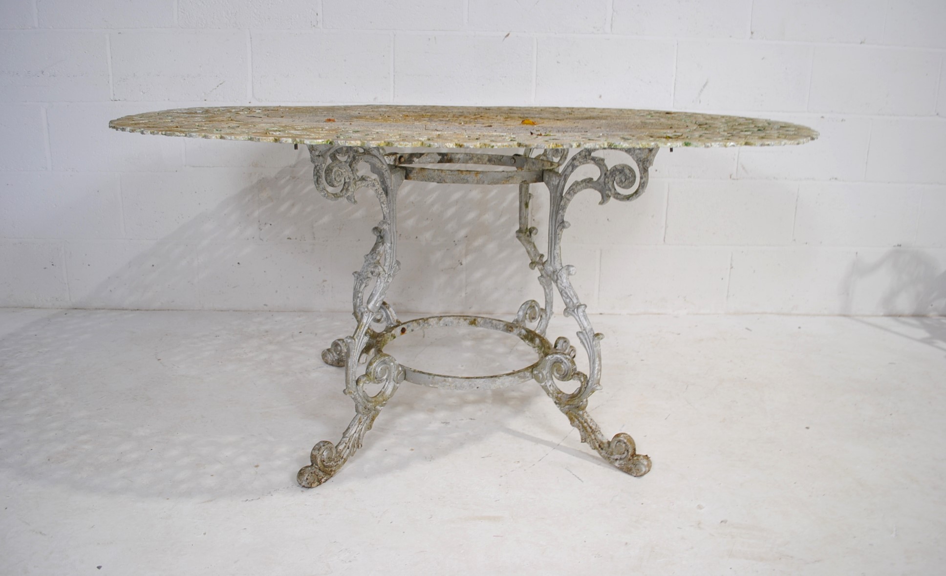 A weathered cast aluminium circular garden table with a set of eight chairs, with lyre backs - one - Image 7 of 12