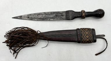 An African dagger with leather handle and sheath decorated with woven design