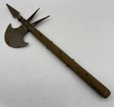 A medieval style battle axe with studded wooden handle