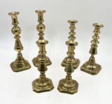 Three pairs of brass candlesticks - one of the smallest pair loose