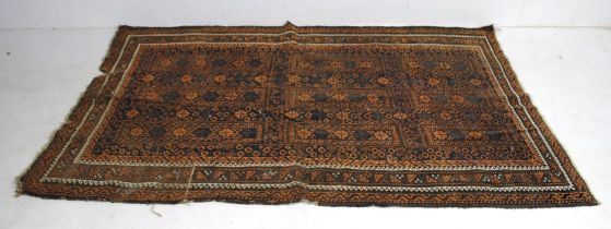 An orange ground traditional Eastern rug, with geometric patterns - some slight wear and repair -