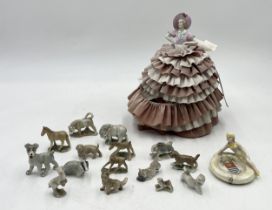 A collection of early Wade Whimsies along with a half doll pincushion etc.