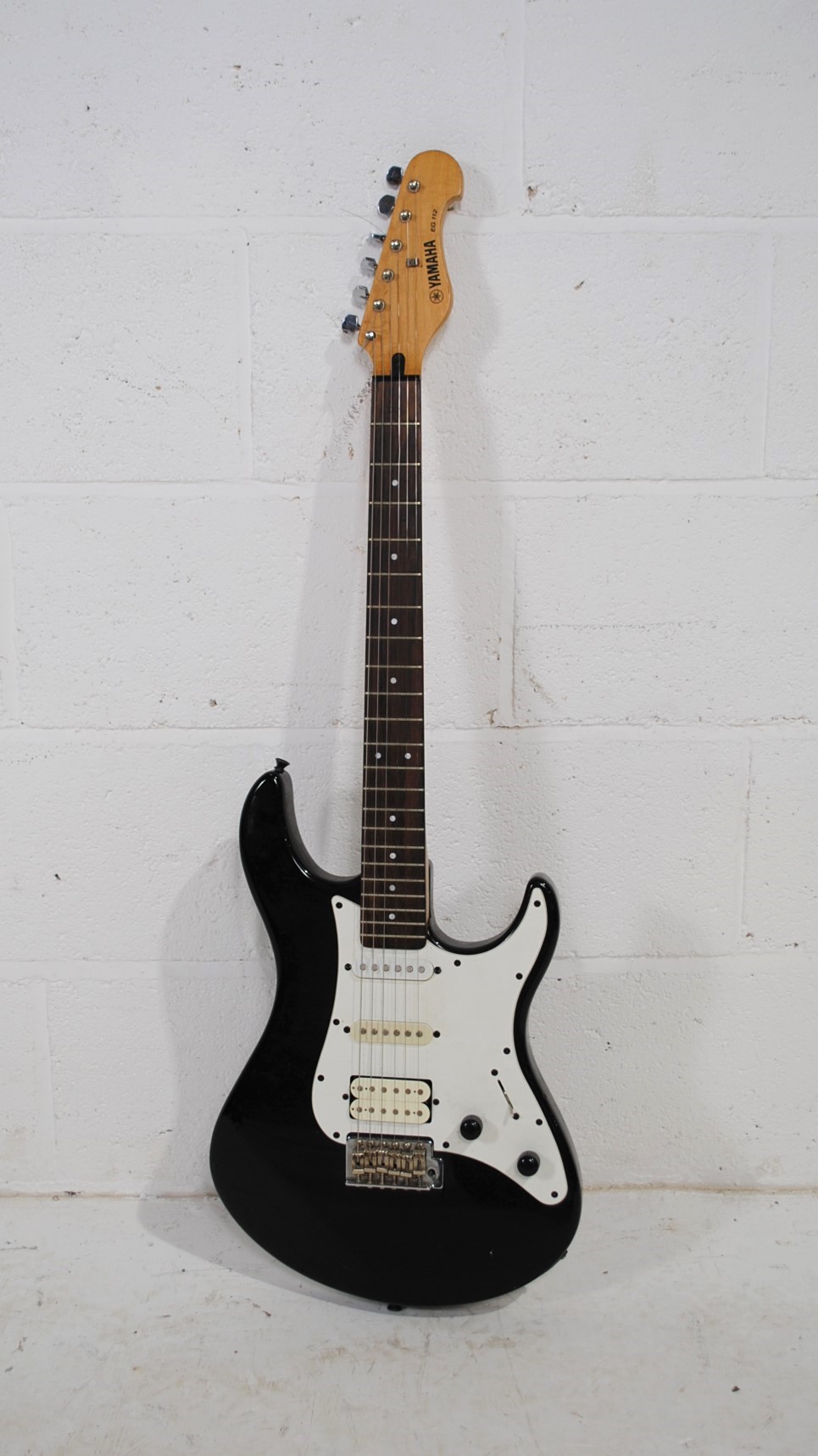 A Yamaha EG 112 black Stratocaster electric guitar