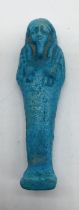 An Egyptian blue faience Shabti with hieroglyphs to reverse, 7cm height