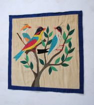 An embroidered fabric wall hanging, depicting tropical birds amongst foliage - 90cm x 89cm