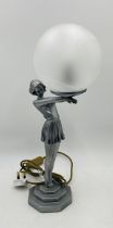 An Art Deco style table lamp in the form of a young lady holding a globe - Overall height 50cm