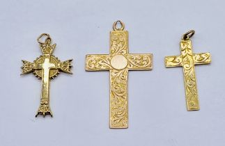 Three 9ct gold crosses, total weight 4g