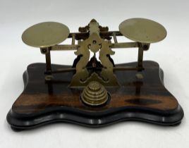 A set of brass postal scales and weights on coromandel base by Martin & Co, Cheltenham