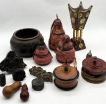 A collection of Eastern and Indian items including wooden printing blocks, baskets, incense