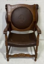 A metamorphic oak seat/table with carved crown and Fleur de Lys design