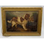 A small oil painting circa 1900 of a spaniel with a game bird, overall size 26cm x 36cm