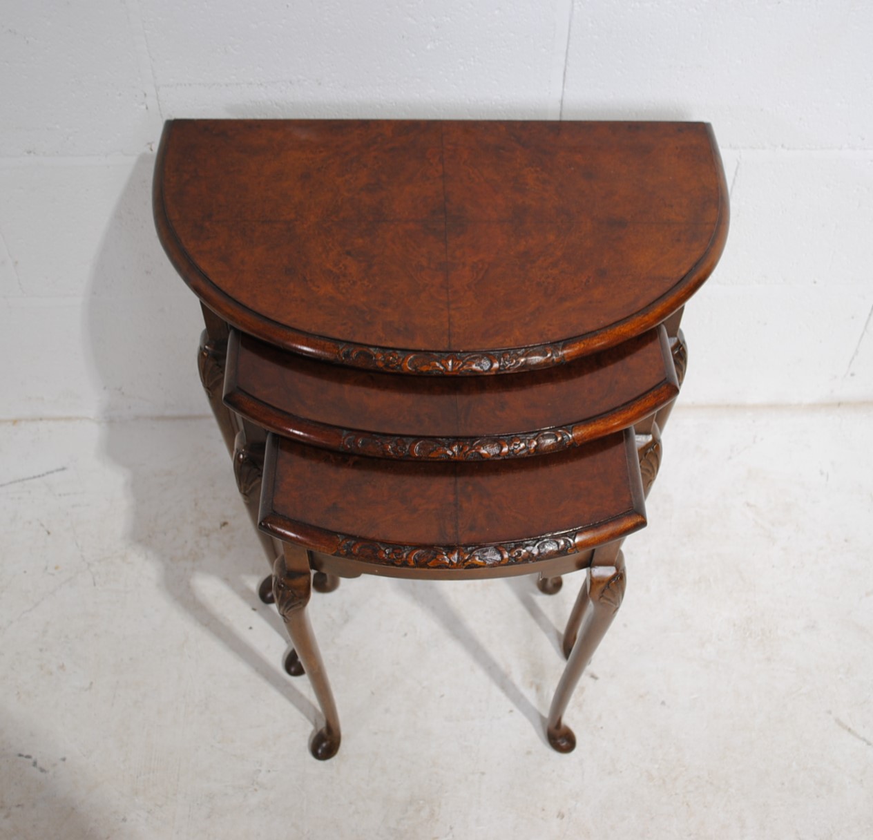 A walnut veneered nest of three demi-lune tables, with carved decoration, raised in cabriole legs - Image 2 of 6