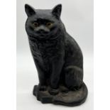 A cast iron doorstop in the form of a black cat