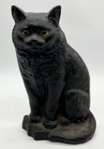 A cast iron doorstop in the form of a black cat