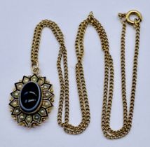 An unmarked gold Victorian enamelled memorial/mourning pendant set with a banded agate and seed