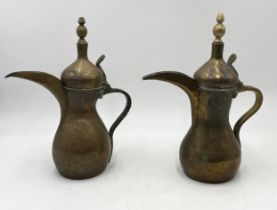 Two Eastern Dallah coffee pots, one with damage as shown