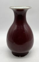 A Chinese Sang de Boeuf glazed porcelain vase - height 36cm- chips to base