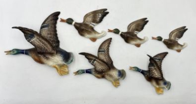 A set of three Jema graduated flying ducks along with a smaller set by Markay