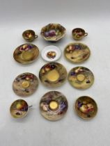 A collection of mis-matched hand painted Royal Worcester cups, saucers and dishes all decorated with