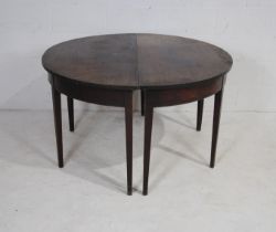 A pair of Georgian mahogany demi lune tables, raised on tapering legs