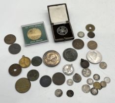 A small collection of coins and medallions including one for London Northeastern Railway