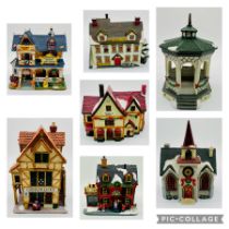 A collection of Lemax Christmas village houses, all can be illuminated, some with boxes