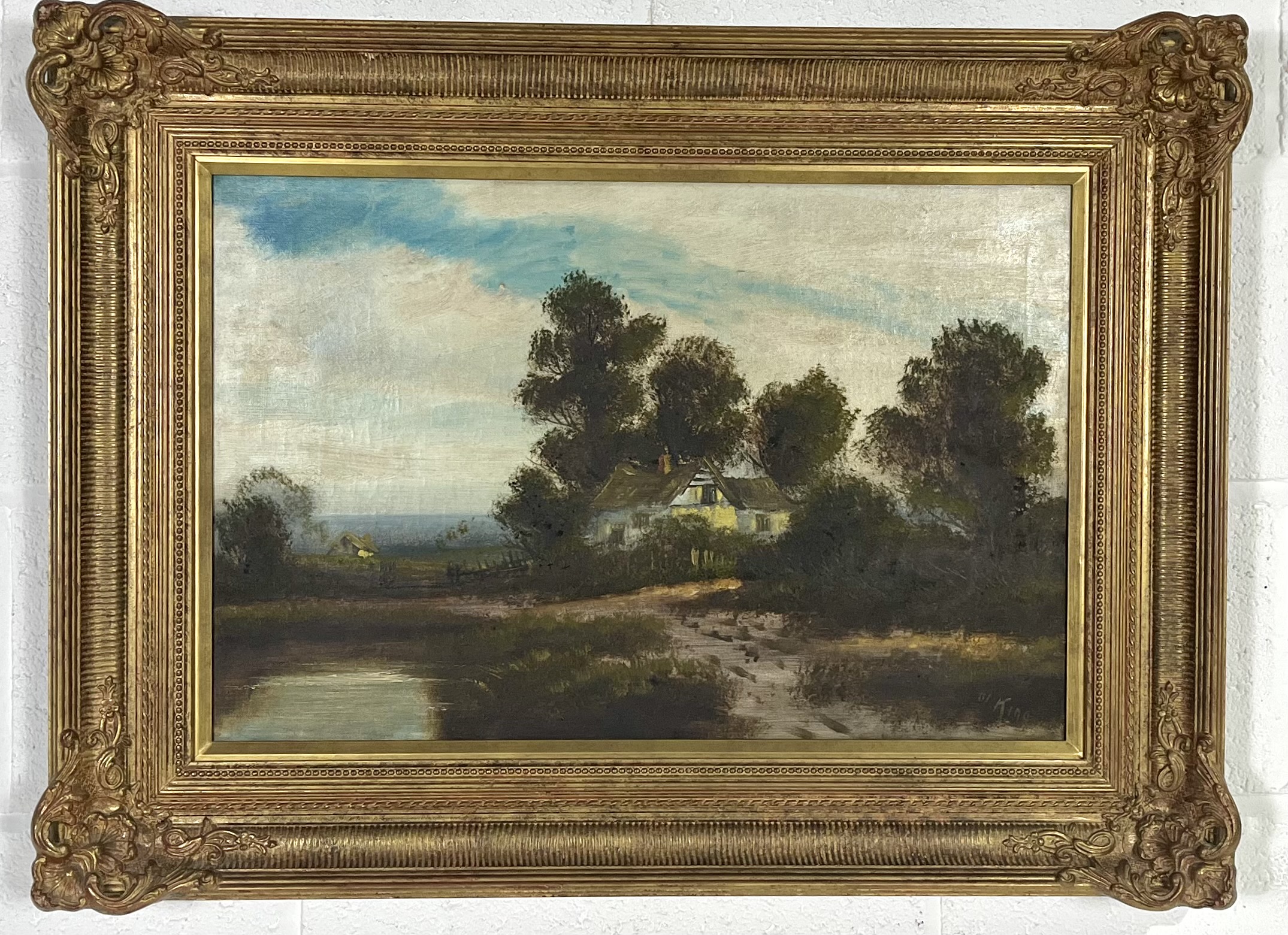 An oil on canvas painting of a river scene in an ornate gilt frame, signed W. King, overall size