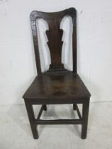An antique oak splat back country chair