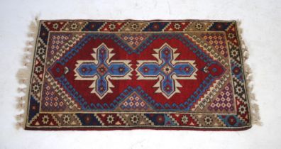 A red ground Kilim rug, with geometric designs - 134cm x 75cm