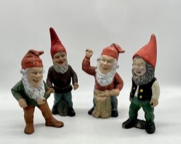 Four weathered garden gnomes, all missing tools. Height 31cm approx.