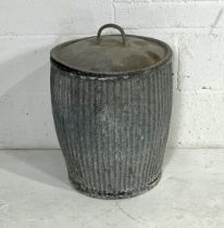 A weathered galvanised washing dolly tub.