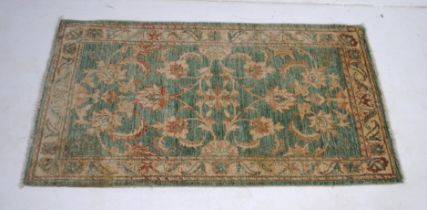 A green ground Eastern rug - 158cm x 86cm