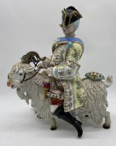 A large Dresden porcelain figure group of Count Bruhl's tailor, modelled in flamboyant attire,