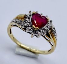 A heart shaped ruby and diamond cluster ring set in 9ct gold, size P 1/2