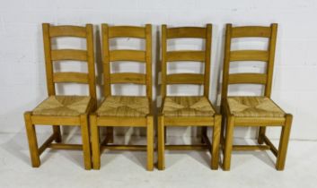 A set of four modern oak dining chairs with rush seats