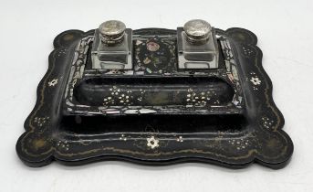 A Victorian papier mâché inkwell with inlaid mother of pearl detail