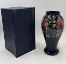 A boxed Moorcroft baluster vase in the Anemone pattern - height 32cm