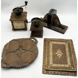 An assortment of items including coffee grinders, bookends, carved wooden dish etc.