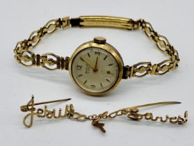 A 9ct gold Avia wristwatch on rolled gold strap along with a tested gold brooch (1.2g)