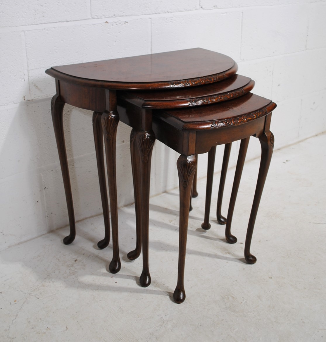 A walnut veneered nest of three demi-lune tables, with carved decoration, raised in cabriole legs - Image 4 of 6