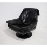 A 1970's black leather swivel armchair