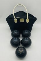 A set of four vintage Lignoid Tru-Grip bowls, along with one other, all in a carry bag