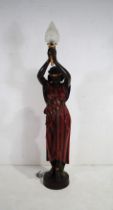 A 20th century large painted plaster figural standard lamp on pedestal base, in the Art Deco style