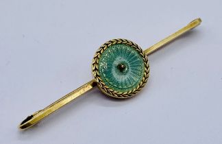 A 15ct gold and enamelled brooch, seed pearl missing from centre, weight 4.1g