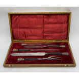 A Victorian oak cased five piece carving set with silver mounts depicting rams heads, by Joseph